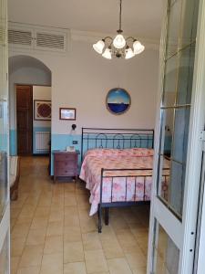 a bedroom with a bed with a pink comforter at Locanda Miranda in Tellaro