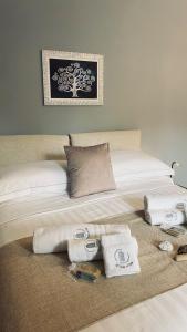 a bedroom with a bed with towels on it at Le Chicche del Porto - Allure in Genova