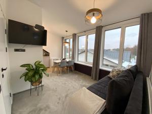 un soggiorno con divano e una grande finestra di Salt Garden Superior double rooms a Druskininkai