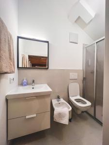 a bathroom with a sink and a toilet at Holy View Apartment in Bolzano