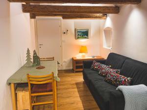 a living room with a black couch and a table at Holy View Apartment in Bolzano