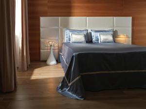 アグローポリにあるLa Frescura del Principe Dimora di Charmeのベッドルーム(黒いベッド、青い枕付)