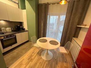 a kitchen with a table and chairs in a room at Industrial Touch - designed in Iaşi