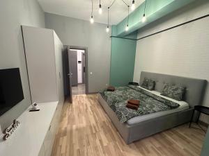 a bedroom with a bed and a television in it at Industrial Touch - designed in Iaşi