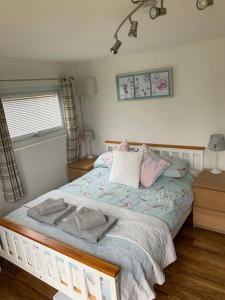 a bedroom with a bed with towels on it at The Old Beauty Room in Paulton