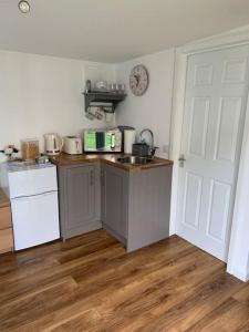 a kitchen with a sink and a counter top at The Old Beauty Room in Paulton