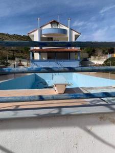 a swimming pool in front of a house at Megisti in Mourteri