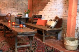a room with a bench and a table and candles at RubyJune Inn in White Salmon