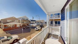 a balcony of a house with a view of a street at Beach House Steps away from the Boardwalk and Beach with Ocean Views in Seaside Heights! in Seaside Heights