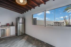 a kitchen with a refrigerator and a window at Villa Winter APT 1 in Funchal