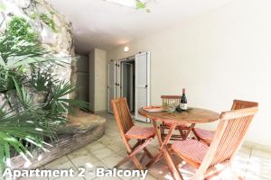 a patio with a wooden table and chairs at Art Apartments Vrsar in Vrsar