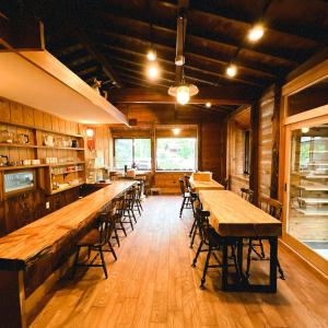 a dining room with wooden tables and chairs at irodori in Matsumoto