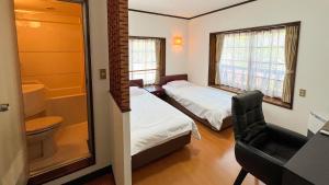 a small room with two beds and a bathroom at irodori in Matsumoto