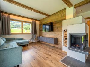 a living room with a couch and a fireplace at Chalet Bodahof in Aschau