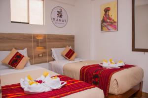 מיטה או מיטות בחדר ב-Runas Inn Machupicchu