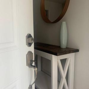 a mirror and a vase on a table in a room at Modern 4 season cottage retreat in Huntsville