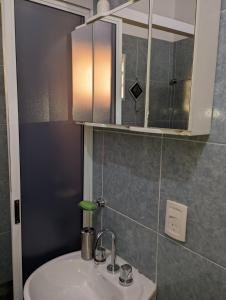 a bathroom with a sink and a mirror at Departamento Iguazú Cataratas in Puerto Iguazú