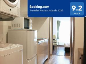 uma cozinha com um frigorífico e um micro-ondas em Best ever hotel -SEVEN Hotels and Resorts- em Naha