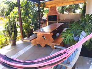 a hammock on a patio with a table and a fireplace at Departamento Iguazú Cataratas in Puerto Iguazú