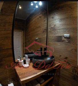 a mirror in a bathroom with a counter with a sink at Cabañas Boutique Aires del Toro, Curacaví in Curacaví