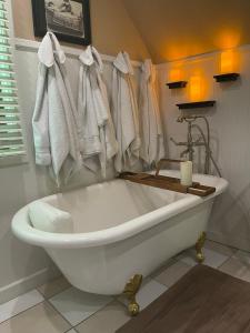 a white bath tub in a bathroom with a candle at Downtown B&B with Jacuzzi in Glenwood Springs