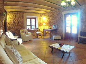 a living room with a couch and a table at Ca'n Fosquet in Llucmajor