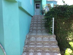 a set of stairs in front of a blue building at Abigail's Spectacular 2 bedrooms-Entire Apartment in Tortola Island