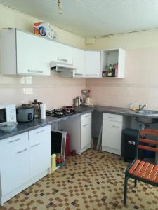 a kitchen with white counters and white cabinets at Villa VICTORIA in Le Lamentin