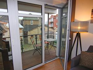 a room with a balcony with sliding glass doors at Holiday Home Sturmeck, Fehmarn-Orth in Orth