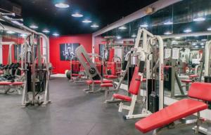 a gym with lots of red chairs and machines at 7th - 7 Heaven Miami - Stunning Ocean View - Free Parking in Miami Beach