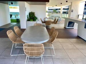 a table and chairs in a room with a table at Koko luxury apartment in Broadbeach in Gold Coast