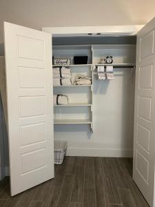 a walk in closet with a white door at Private entrance apartment in Bentonville