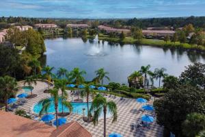 an aerial view of a resort with a lake and a fountain at Welcome to Villa Azul, your home away from home! in Kissimmee