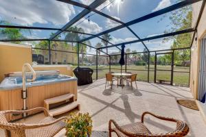 a patio with a hot tub and a table and chairs at Welcome to Villa Azul, your home away from home! in Kissimmee