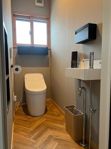 a small bathroom with a toilet and a sink at SLOPE in Kutchan