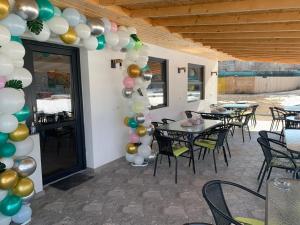 a room with tables and balloons on the wall at Lumea Copiilor Karina&Adelin Lupeni in Lupeni