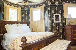 a bedroom with a bed with floral wallpaper at 10 Clarke in Frederick