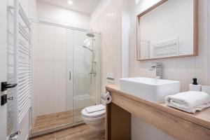 a bathroom with a sink and a toilet and a mirror at N36- Boutique Apartments, Best Location, By BQA in Budapest