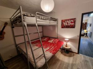 a bedroom with two bunk beds and a lamp at Appartement Saint-Michel-de-Chaillol, 3 pièces, 6 personnes - FR-1-393-162 in Saint-Michel-de-Chaillol