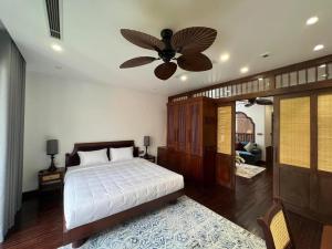 a bedroom with a bed and a ceiling fan at Camellia Residence Hanoi in Hanoi