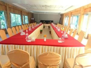 a long table in a room with chairs at Himalayan Deurali Resort in Pokhara