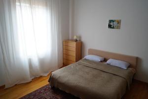a small bedroom with a bed and a window at Appartamento Mirandola in Mirandola