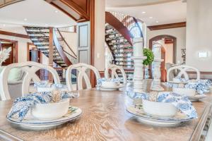 a dining room with blue and white dishes on a table at French Château w/Swim Spa & Theatre: 11,700 sqft in Calgary