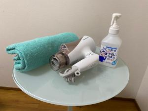 a table with a blow dryer and a towel at Kanazawa Guesthouse Stella in Kanazawa