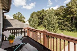 a balcony with a wooden deck with a table and chairs at Meet Me in Athens I Beautiful 4-Bdrm House I 1 Mile to DT and Mins to UGA in Athens