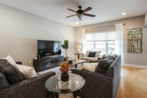 a living room with two couches and a tv at Meet Me in Athens I Beautiful 4-Bdrm House I 1 Mile to DT and Mins to UGA in Athens