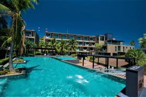 a large swimming pool in front of a building at Pixel Condo - Panwa Beach in Ban Ao Makham