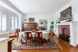 a dining room with a table and chairs and a fireplace at Villa de 5 chambres avec piscine privee jardin clos et wifi a Bourre a 4 km de la plage in Bourré
