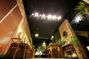 a restaurant with a brick wall and a chandelier at PENGHU Lucai B&B 旅采民宿 in Magong