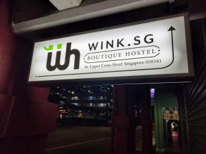 a sign for a building that says winks sg boutique hospital at Wink at Upper Cross Street in Singapore